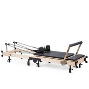 Elina Pilates Fold Reformer set up, black upholstery, angled view