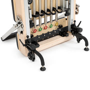 Base of the stored Vertical Reformer: five color-coded springs, transport wheels and adjustable feet, black