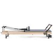 Vertical Reformer set up flat, grey upholstery, side view
