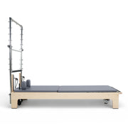 Club Reformer with Tower side view, full-length mat conversion, grey