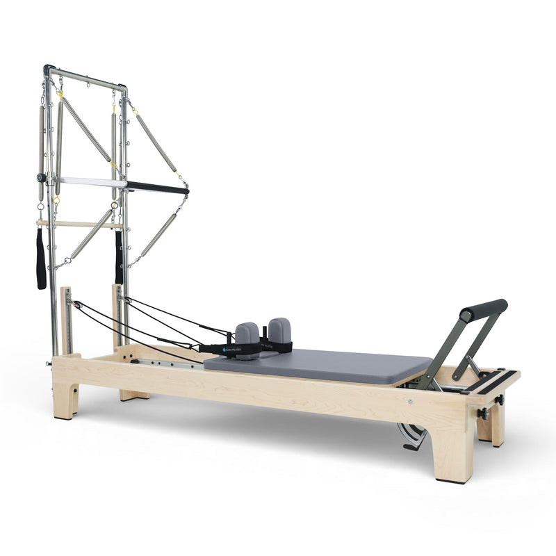 Elina Pilates Club Reformer with Tower fully rigged, grey upholstery, angled studio view