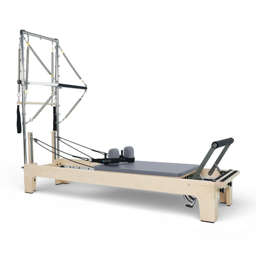 Elina Pilates Club Reformer with Tower fully rigged, grey upholstery, angled studio view