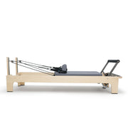 Club Reformer side view with cords stretched to the risers, grey