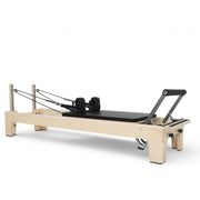 Elina Pilates Club Reformer, black upholstery, angled studio view