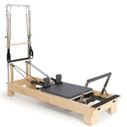 Elina Pilates Wood Reformer with Tower in grey, angled studio view