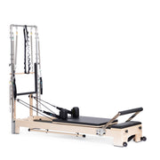 Lignum Reformer with Tower in black, ropes and shoulder rests visible